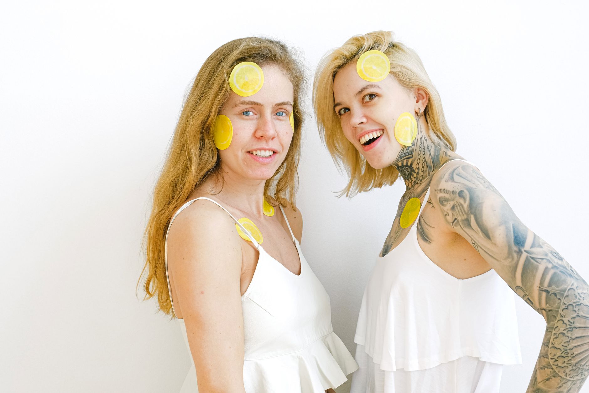 Hands holding silicone lemon vibrators against a soft background