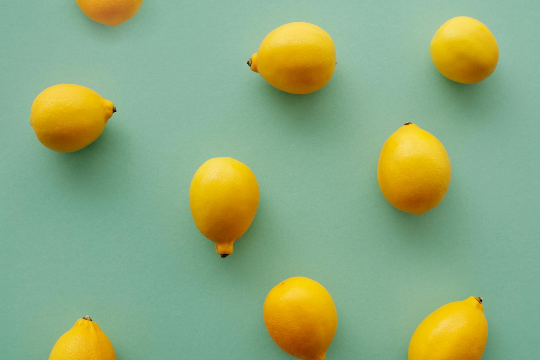 Fresh lemons arranged on a pastel background, symbolizing the Lem vibrator